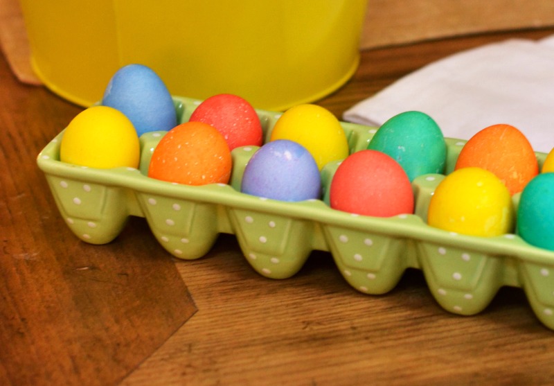 close up of colored Easter eggs on an antique table